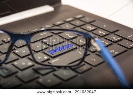 View Of The Pc Keyboard Through The Lens Of The Glasses On The Button With The Written Presbyopia