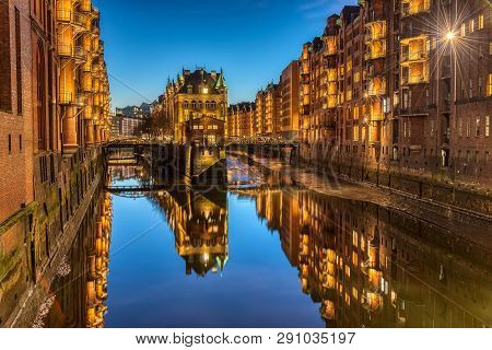 The Old Speicherstadt With The Wasserschloss In Hamburg, Germany, At Twilight