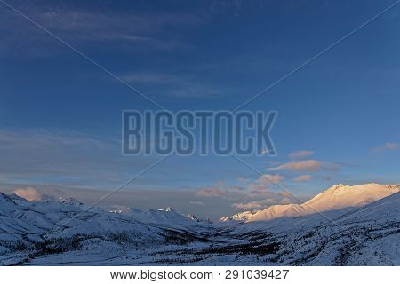 Winter Sunrise On The Top Of Tombstone National Park Mountains