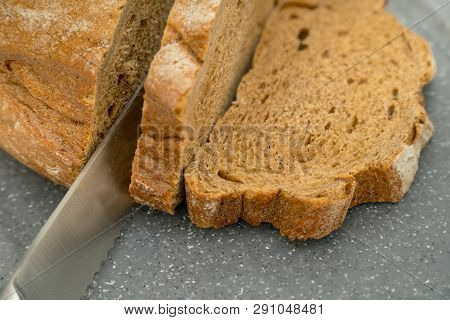 Sliced Bread And Knife On A Gray Background