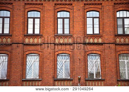 The Facade Of The Building Of Red Bricks With Windows