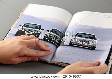 Tambov, Russian Federation - November 3, 2012 Woman Browses A Catalog At A Mercedes-benz Cars Dealer