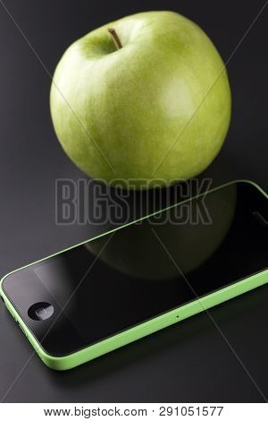 Tambov, Russian Federation - October 16, 2013 Apple Iphone 5c Green Color And Green Apple On Black B