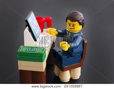 Tambov, Russian Federation - March 24, 2015 Lego Businessman Sits At His Working Table With Computer