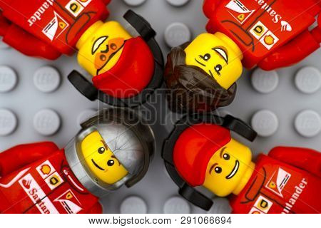 Tambov, Russian Federation - June 15, 2017 Four Lego Ferrari Team Crew Members Minifigures On Gray B