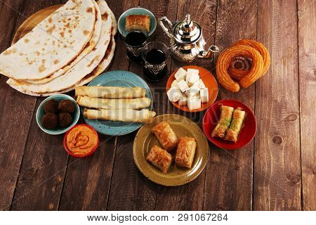 Middle Eastern Or Arabic Dishes And Assorted Meze, Concrete Rustic Background. Turkish Bread Or Turk