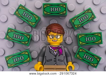 Tambov, Russian Federation - June 22, 2017 Lego Businesswoman And Lego Money On Gray Baseplate Backg