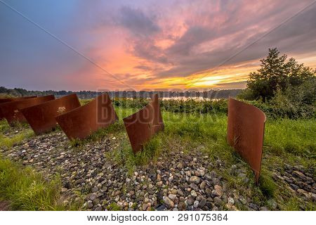 Metal Curved Objects In Natural Landscape With Lake And Sunset At Piccardthofplas Groningen City, Ne