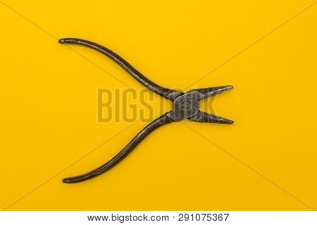 Rusty Pilers Isolated On Yellow Background. Tool