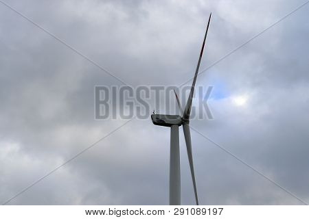 View On Alternative Energy Windmills In A Windpark In Northern Germany In Front Of A Blue Sky
