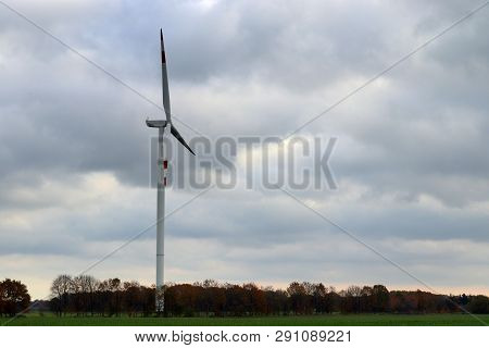 View On Alternative Energy Windmills In A Windpark In Northern Germany In Front Of A Blue Sky