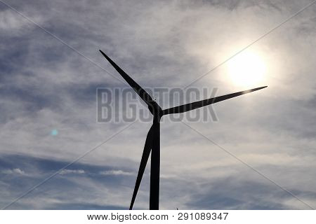 View On Alternative Energy Windmills In A Windpark In Northern Germany In Front Of A Blue Sky
