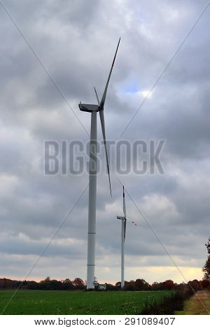 View On Alternative Energy Windmills In A Windpark In Northern Germany In Front Of A Blue Sky