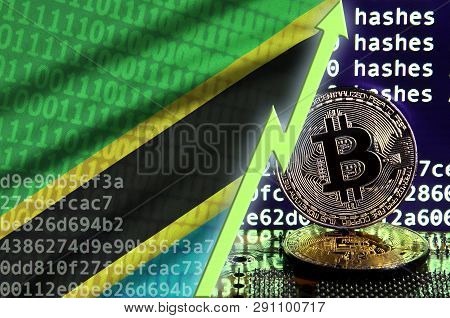 Tanzania Flag And Rising Green Arrow On Bitcoin Mining Screen And Two Physical Golden Bitcoins
