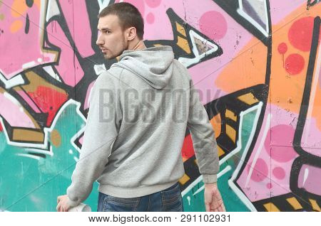 A Young Graffiti Artist Looks Around While Drawing. Vandal Tries
