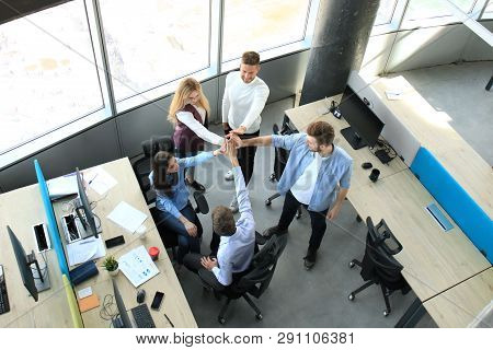 Top View Of Young Modern Colleagues In Smart Casual Wear Working Together While Spending Time In The