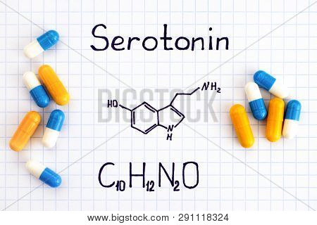 Chemical Formula Of Serotonin With Some Pills. Close-up.