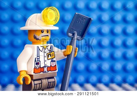 Tambov, Russian Federation - March 09, 2018 Lego Miner With Shovel. Blue Baseplate Background.