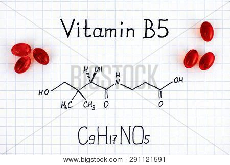 Chemical Formula Of Vitamin B5 And Red Pills. Close-up.