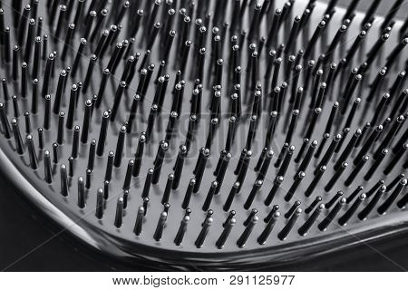 Close-up Of Bristles On Black Hairbrush. Black Background.
