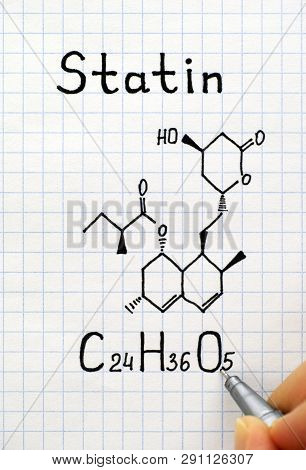 Person Fingers With Pen Writing Chemical Formula Of Statin. Close-up.