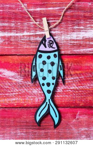 a homemade paper fish, made by myself, as a popular prank for april fools day in countries such as Italy, France, Belgium, Netherlands, Switzerland or Canada hanging from a rope with a clothespin