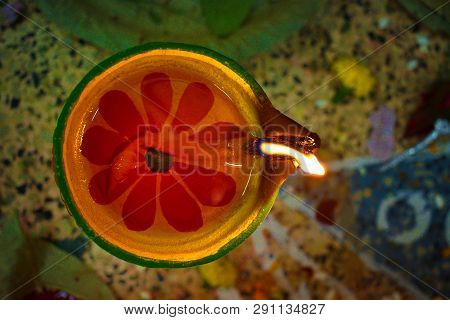 Soil Or Clay Made Pradip ( Lamp ) Radiating Lights . Concept Of Removing Darkness With A Flame.