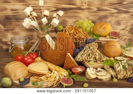 Smoked Cheese Pigtail, Traditional Polish Smoked Cheese, Chechil Cheese On The Wood Background. Smok