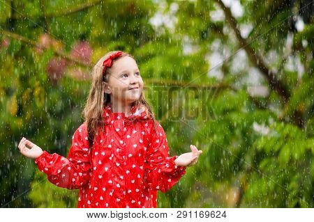 Kids Play In Autumn Rain. Child On Rainy Day.
