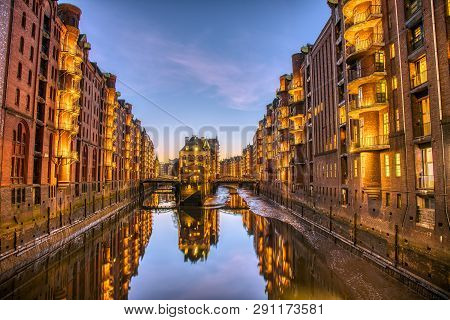 The Old Speicherstadt With The Wasserschloss In Hamburg, Germany, At Dusk