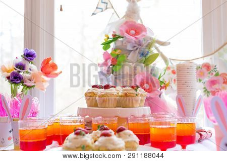 Dessert Table With Cupcakes And Flowers Easter Party Theme