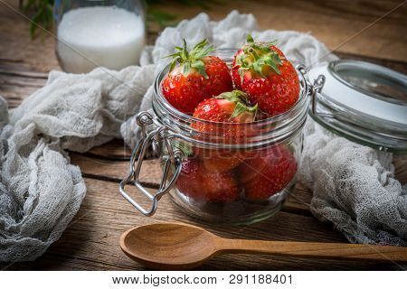 Strawberry In Jar On Wooden Background.