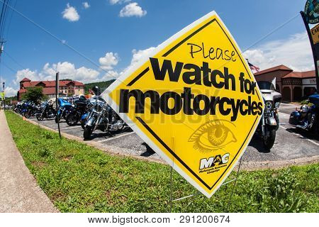Helen, Ga - June 2018:  A Sign Warning People To Watch For Motorcycles, Sits In Front Of A Row Of Mo