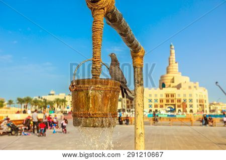 Pigeon At Old Well Fountain On Foreground At Blue Sky, Iconic Landmark In The Middle Of Souq Waqif, 