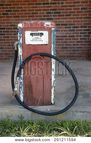 A Close Up View Front Of A Old White, Blue, Red And Black Antique Unused Petrol Pump Used For Show