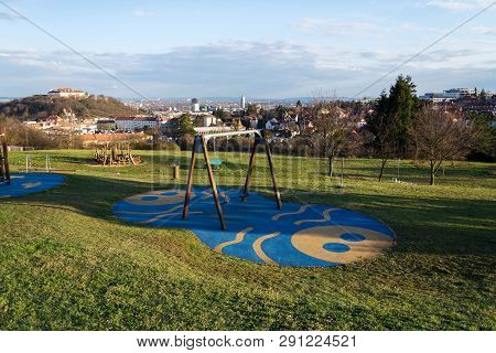 Beautiful Playground With Wooden Swing And Climbing Frames For Children With Spilberk Castle In Back