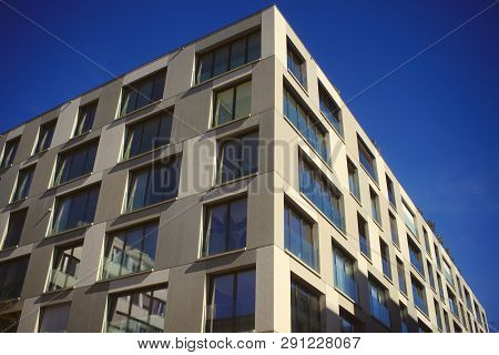 Looking Up To An Urban Window Front Against Blue Sky