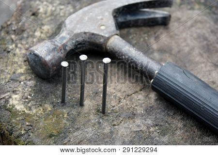 Hammer And Nails On A Wooden Blurred Background