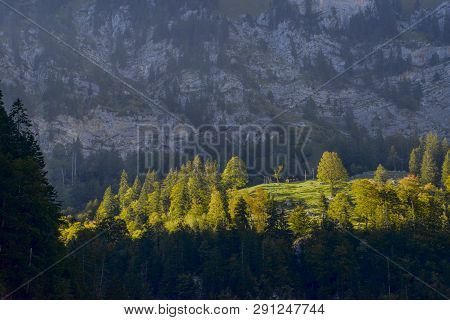 Small Alpine Cottage In Dramatic Evening Light