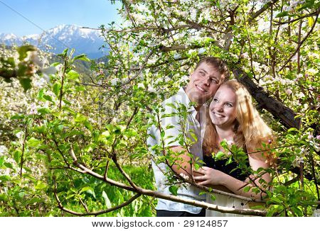 Couple Hugging Around Bloomy Trees