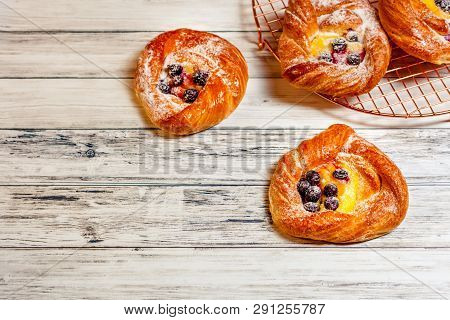 Top View Of Golden Chese Danish Pasties With Blackberries And Powder Sugar