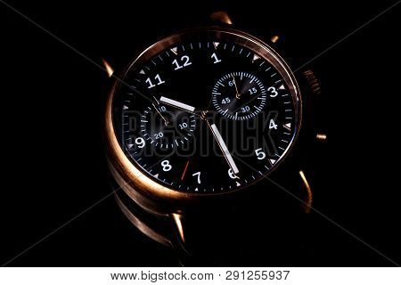 Elegant Copper Wristwatch With Black Dial On Black Background