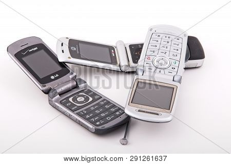 Old Classic Flip Style Cell Phones On White