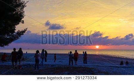 Labuan,malaysia-mac 9,2019:a Group Of People Gather To Watch The Sunset At Layang Layangan Beach In 