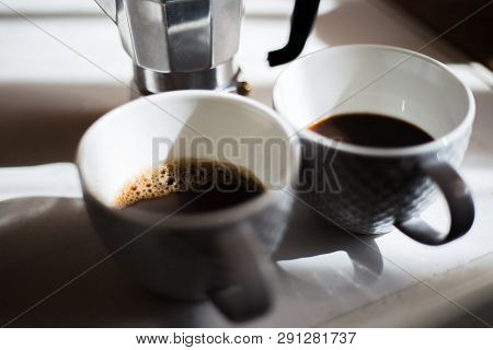 Close Up Of Two Coffee Cups And Moka.