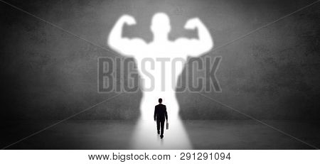 Businessman standing and dreaming about a strong superhero
