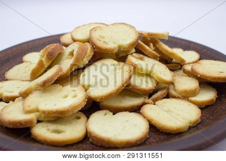 Bake Rolls. The Mini Bread Chips On The Brown Bowl. Isolated On White Background.