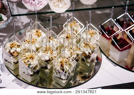 Table With Cakes, Sweets, Candy, Buffet. Dessert Table For A Party Goodies For The Wedding Banquet A