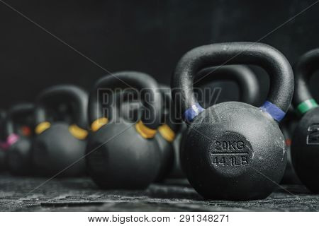 Kettlebells Equipment On Dark Backgroud At The Gym. Sport Concept. Copy Space