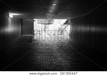 An Underground Passage In Winter With Some Snow On The Stairs In Black And White